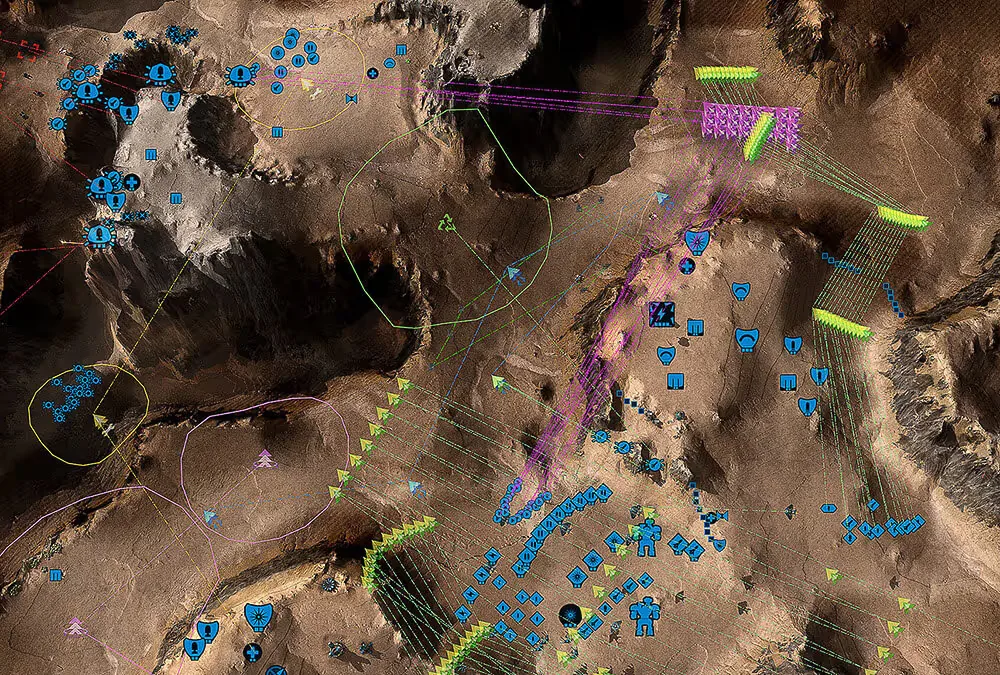 Beyond All Reason strategic battlefield view with blue unit icons, formations and colored movement and attack order lines over rocky terrain.