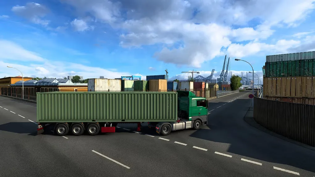Euro Truck Simulator 2 gameplay showing a green truck hauling a container through a freight terminal