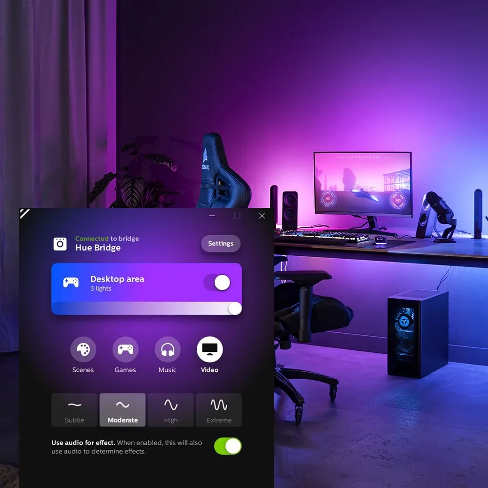 Publisher image of Hue Sync's Windows desktop controls over a gaming setup, showing media modes and lighting intensity options.