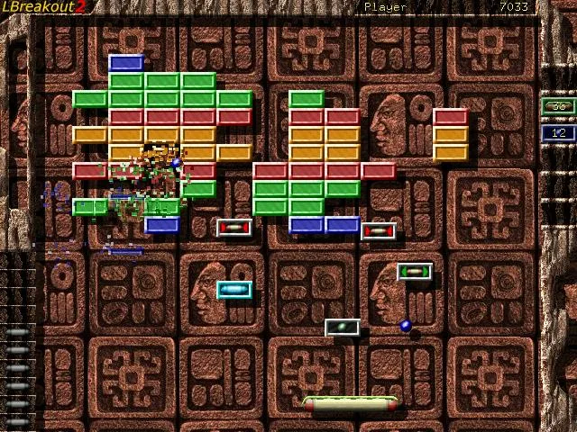 LBreakout2 gameplay with colored bricks, falling bonuses, a blue ball and a green paddle on a stone-patterned playfield.