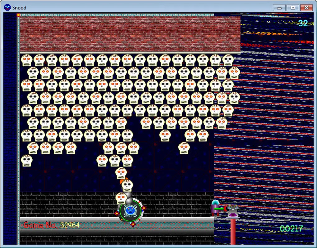 Snood for Windows puzzle board with skull-shaped pieces, launcher, danger gauge and score.