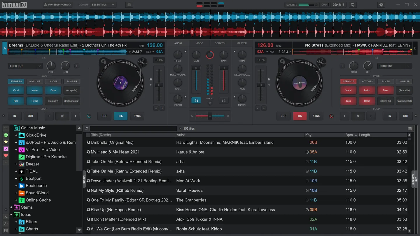 VirtualDJ Essentials interface with two decks, waveforms, stems pads, mixer and track browser; publisher product screenshot