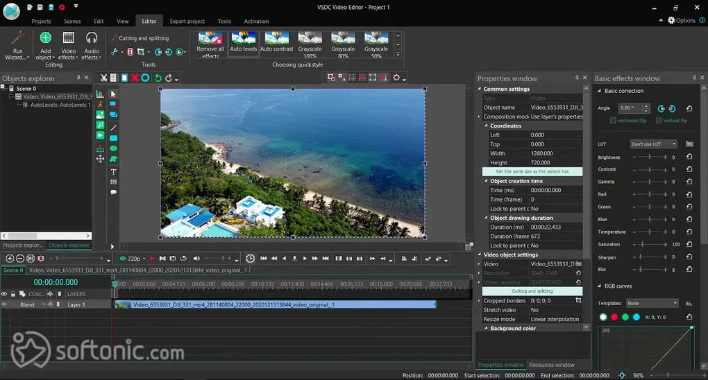 VSDC Video Editor showing a coastal clip preview, object explorer, timeline, and color-correction controls; Softonic watermark visible.