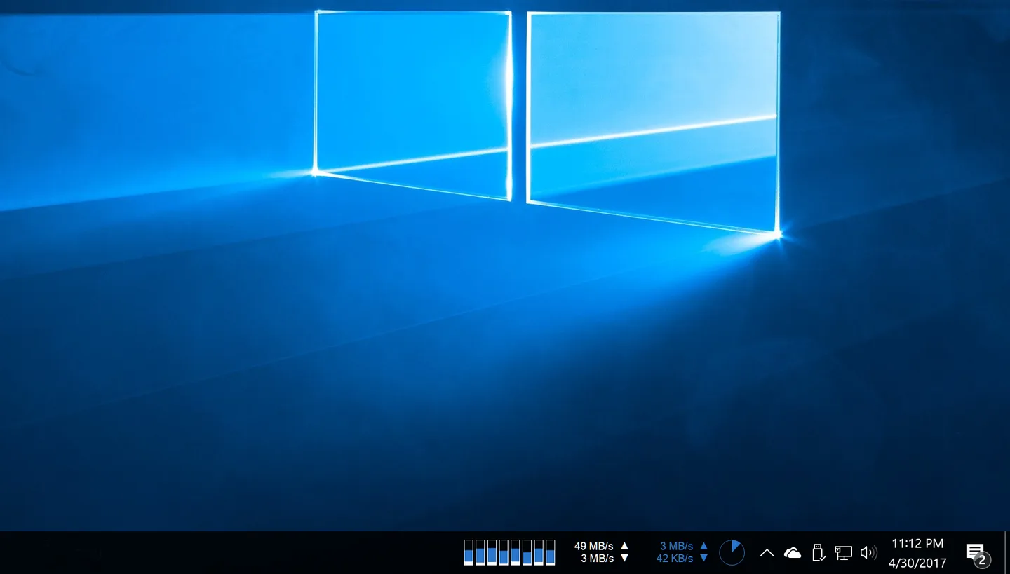 XMeters on a Windows desktop taskbar with CPU bars, disk and network transfer rates, and a memory pie chart.